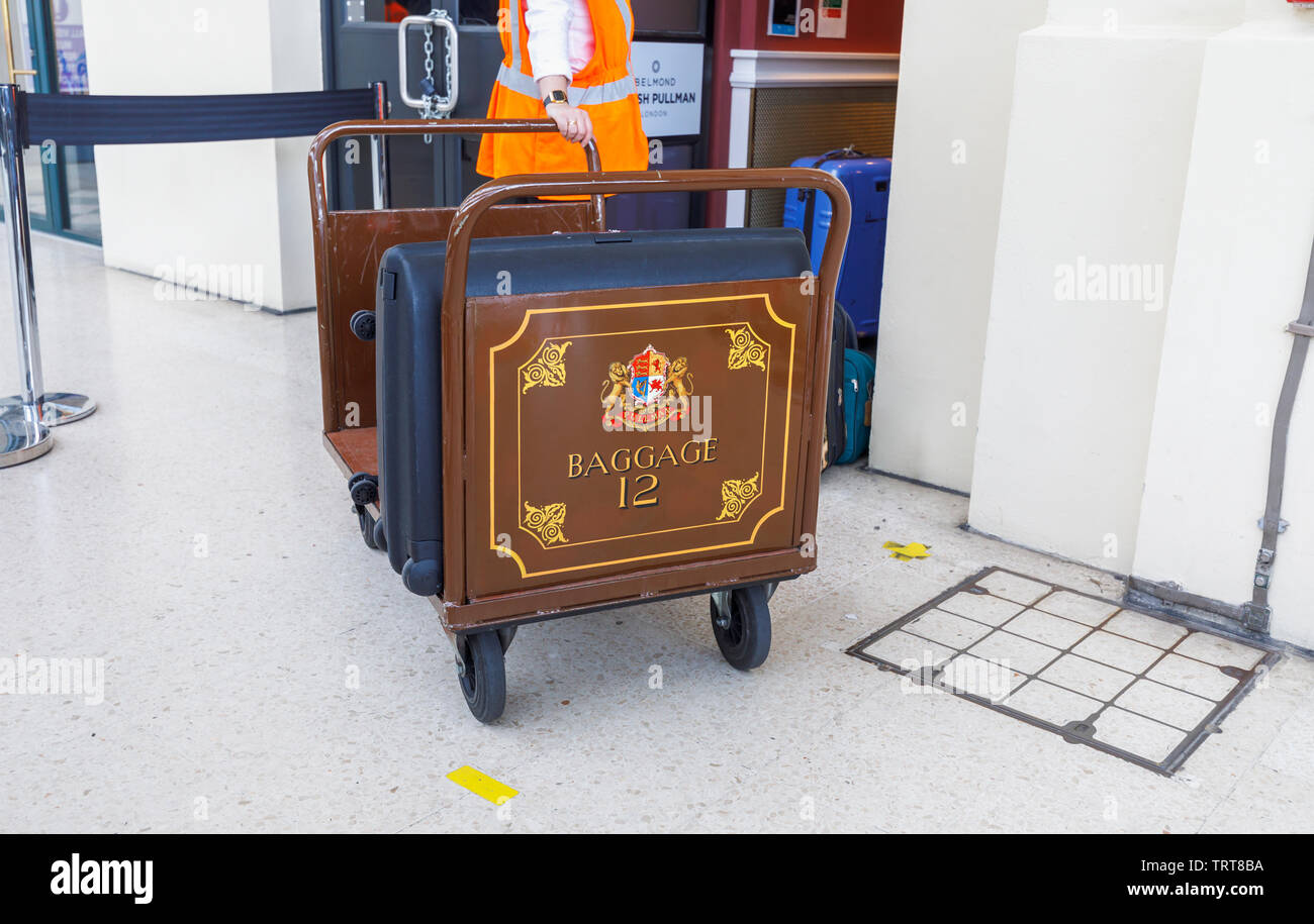 Pullman baggage luggage trolley with suitcases at the entrance to the