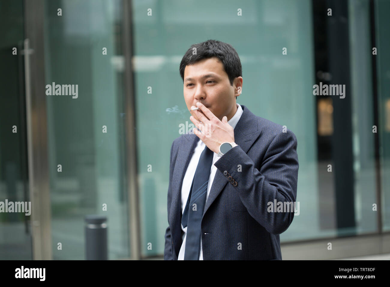 Chinese man in suit smoking hi-res stock photography and images - Alamy