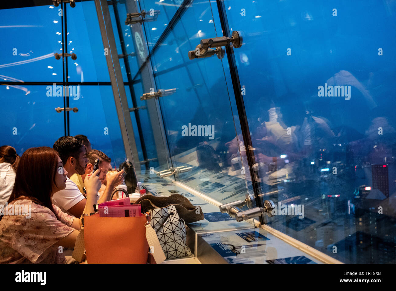 Hong Kong, China - 07 September 2018: People enjoying the view from a Victoria Peak cafe Stock Photo