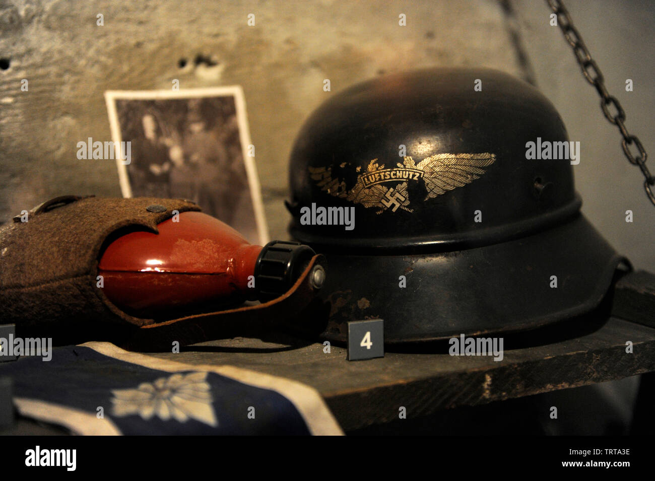 Canteen and helmet of the Luftschutz (protection and German air defense) with anti-aircraft swastika insignia. Property of Mhk. Museum of Oskar Schindler's Factory. Krakow. Poland. Stock Photo