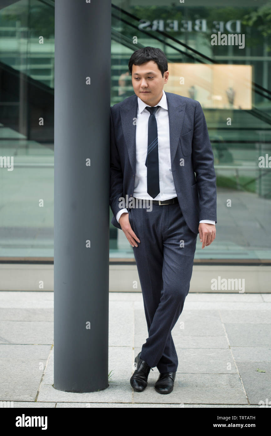 Asian businessman in black suit Stock Photo - Alamy