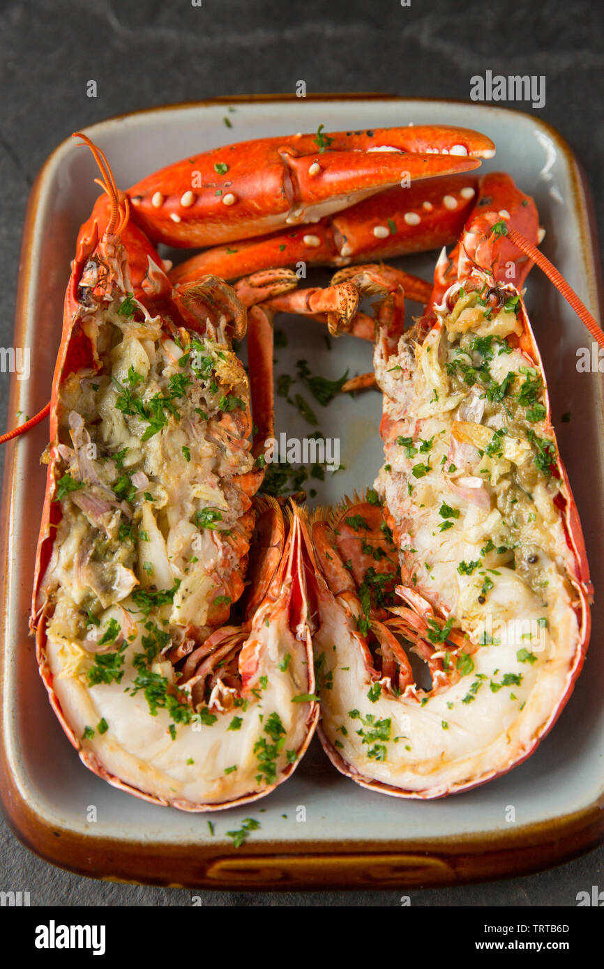 Two halves of a grilled lobster and claws from a lobster, Homarus
