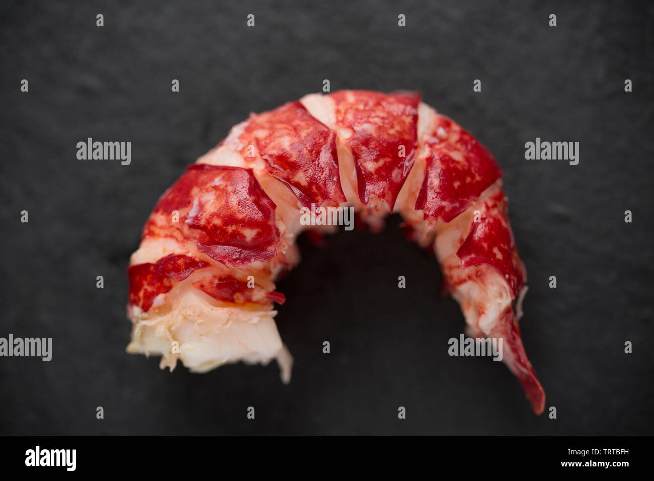 The cooked tail section of a boiled lobster Homarus gammarus, with the shell removed. From a lobster caught in a pot set in the English Channel. Displ Stock Photo