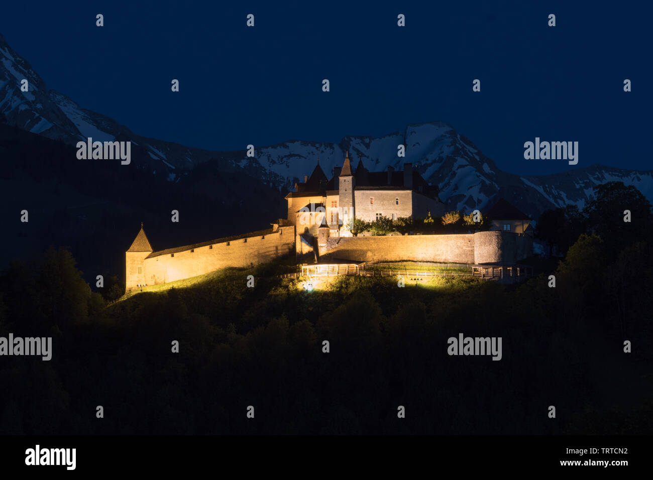 Gruyere, VD / Switzerland - 31 May 2019:  view the historic castle at Gruyere with snowcapped mountain landscape at twilight Stock Photo