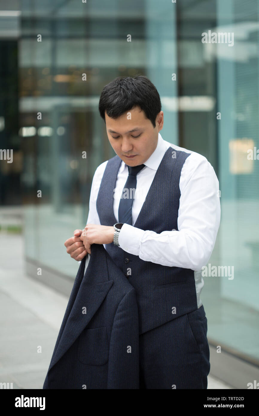 Asian businessman in black suit Stock Photo - Alamy