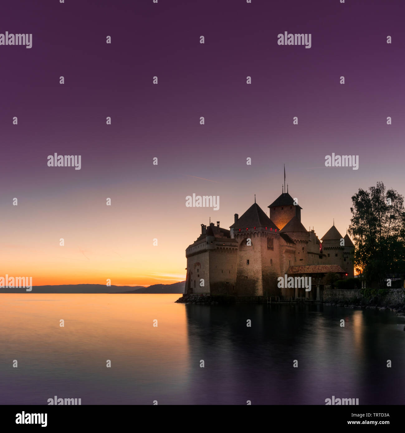 Montreux, VD / Switzerland - 31 May 2019: the historic Chillon Castle on the shores of Lake Geneva at sunset Stock Photo