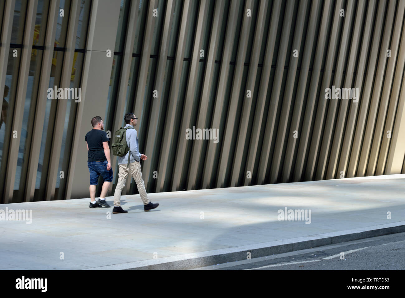 Two Men walking beside 70 St. Mary Axe 'Can of Ham' , City of London, United Kingdom Stock Photo