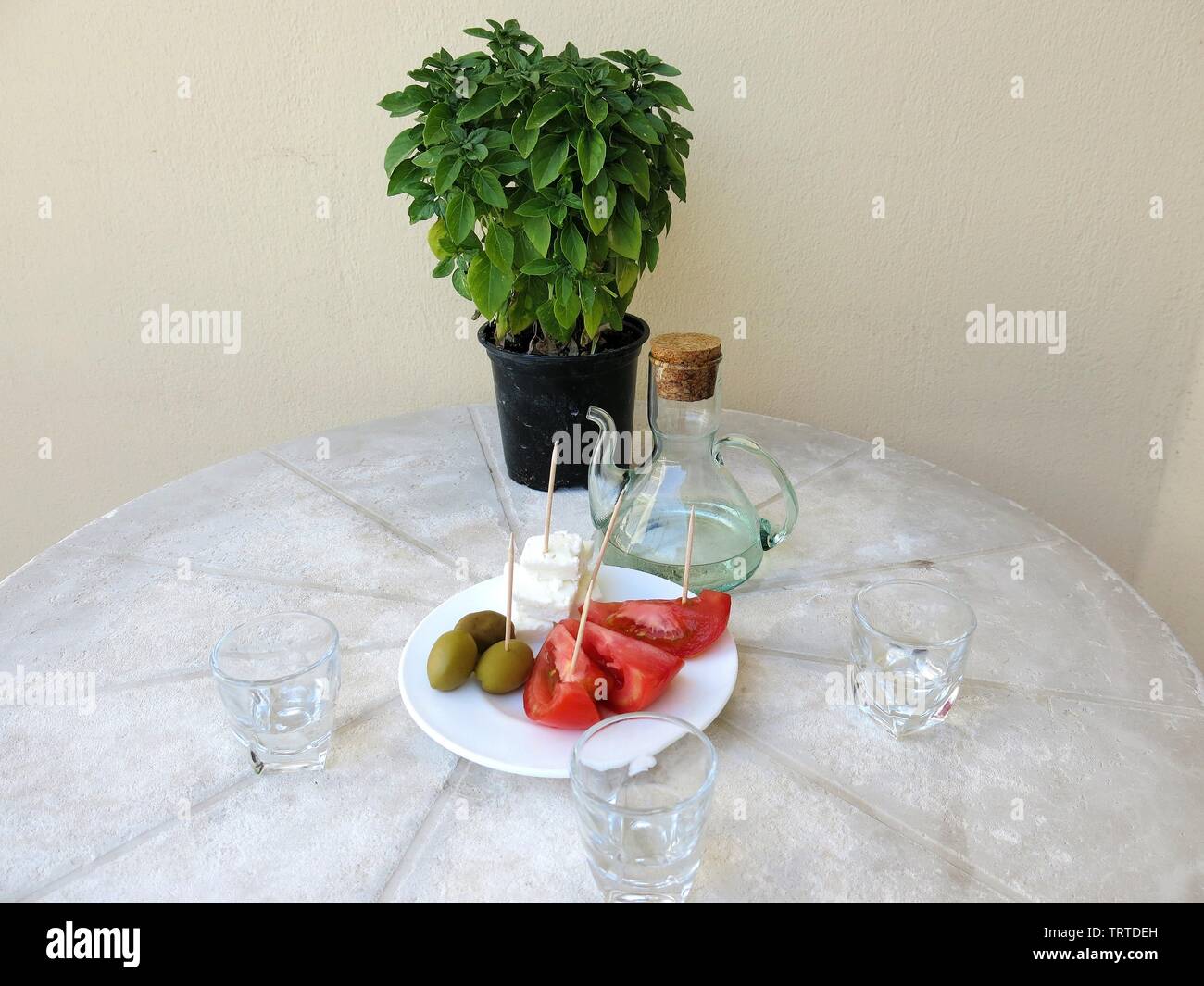 Raki served with a snack or meze as it is called in Greece. Stock Photo