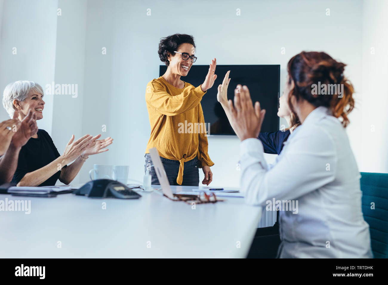 happy business team giving high five in office Stock Photo - Alamy