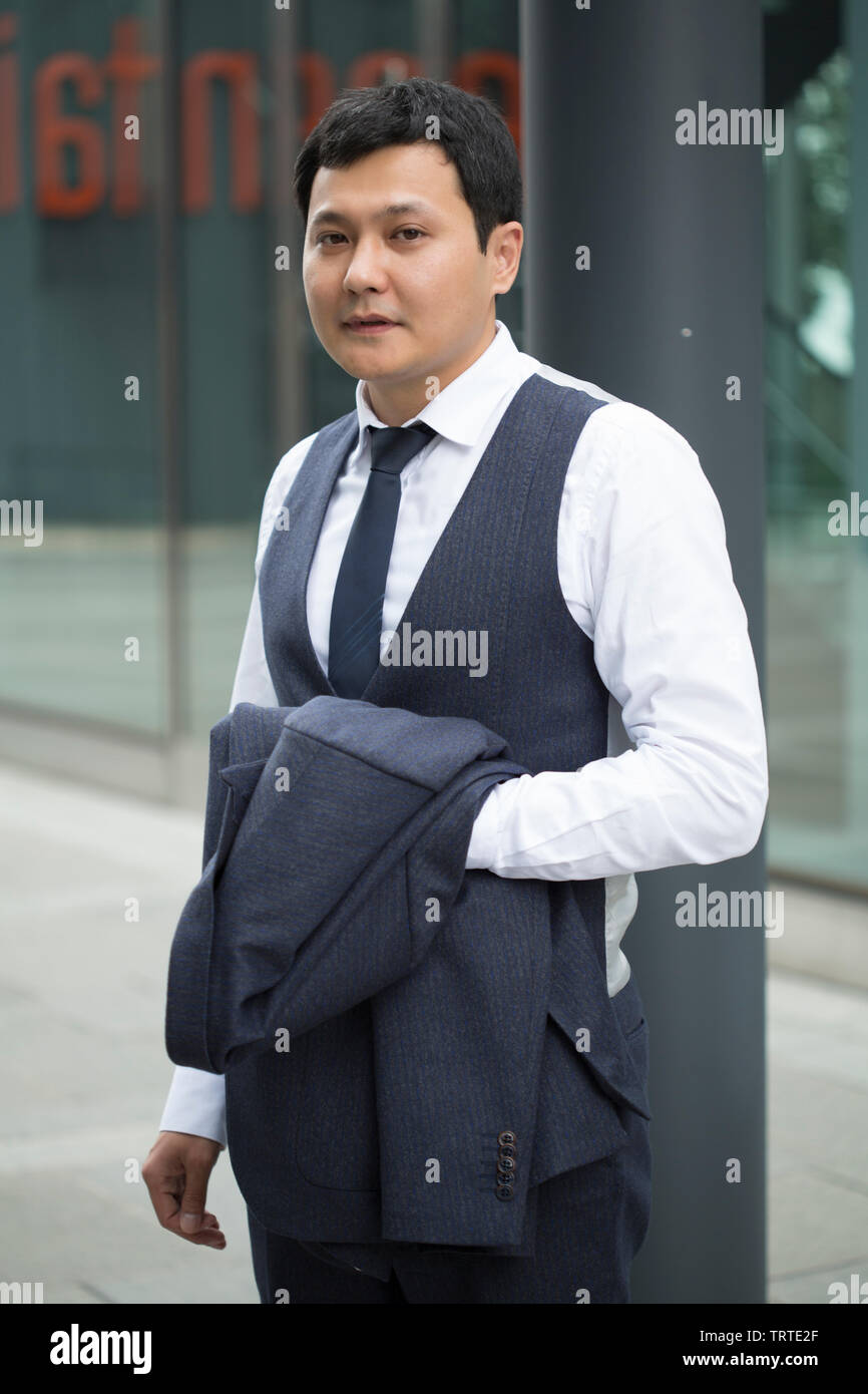 Asian businessman in black suit Stock Photo - Alamy