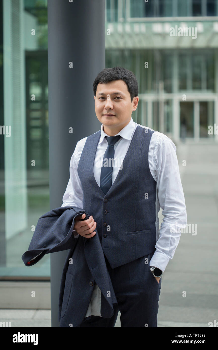 Asian businessman in black suit Stock Photo - Alamy