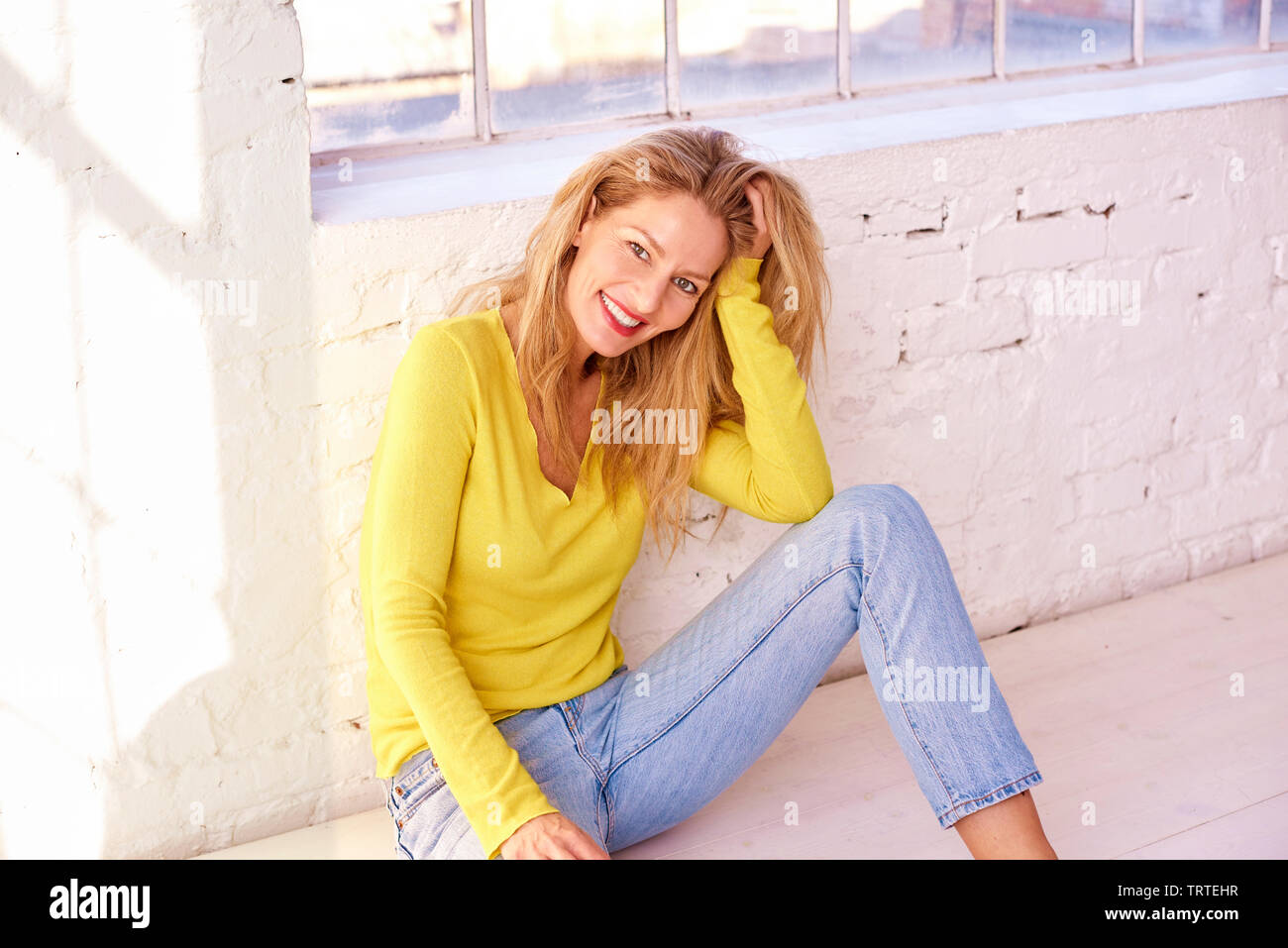 Mature woman sitting floor hi-res stock photography and images - Alamy