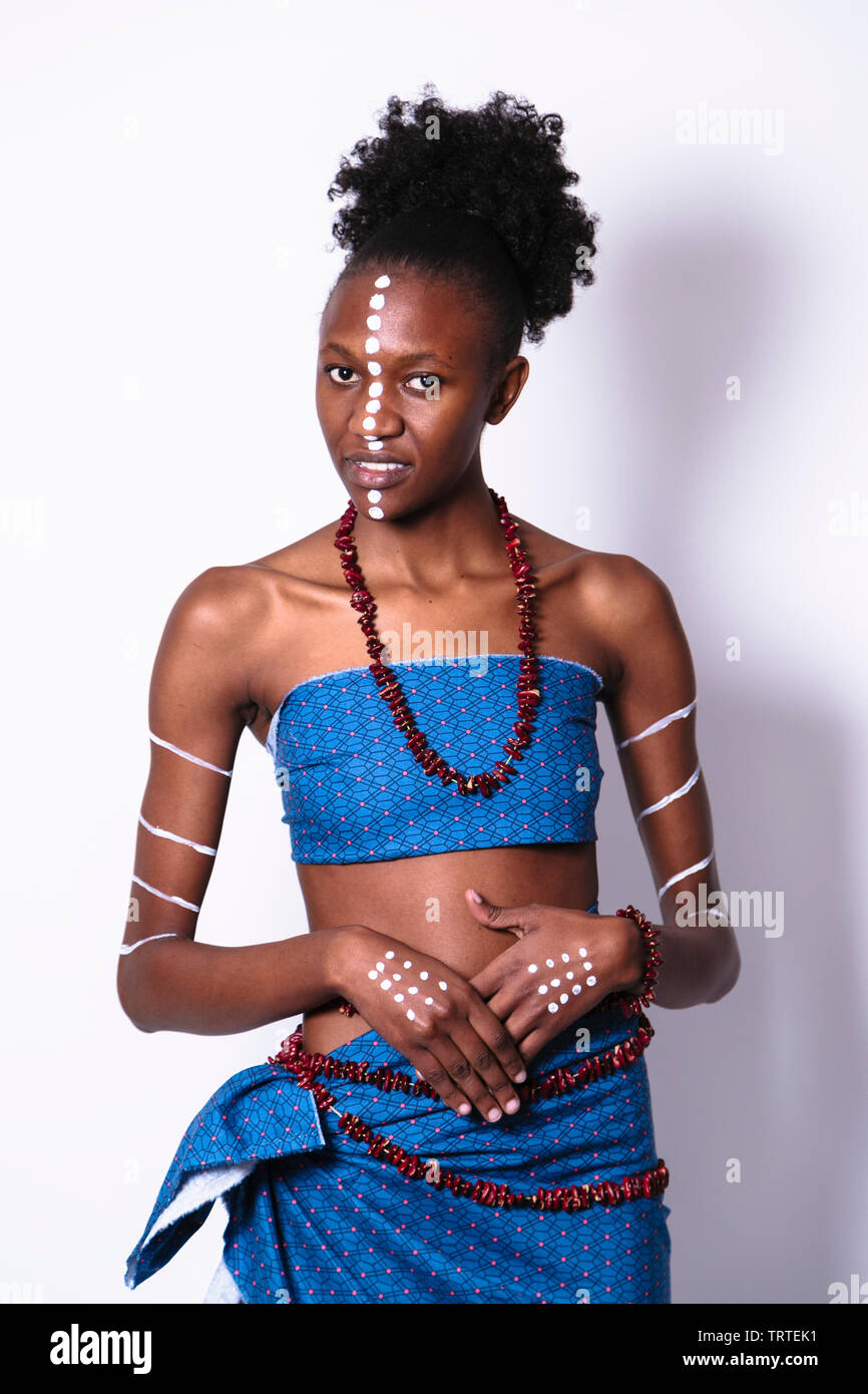 Beautifu young black woman with face and body art in blue clothes with  coral jewelry. Isolated on on grey Stock Photo - Alamy