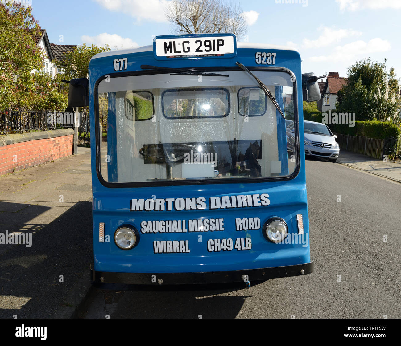 An original milk float still in use in Wirral England UK Stock Photo