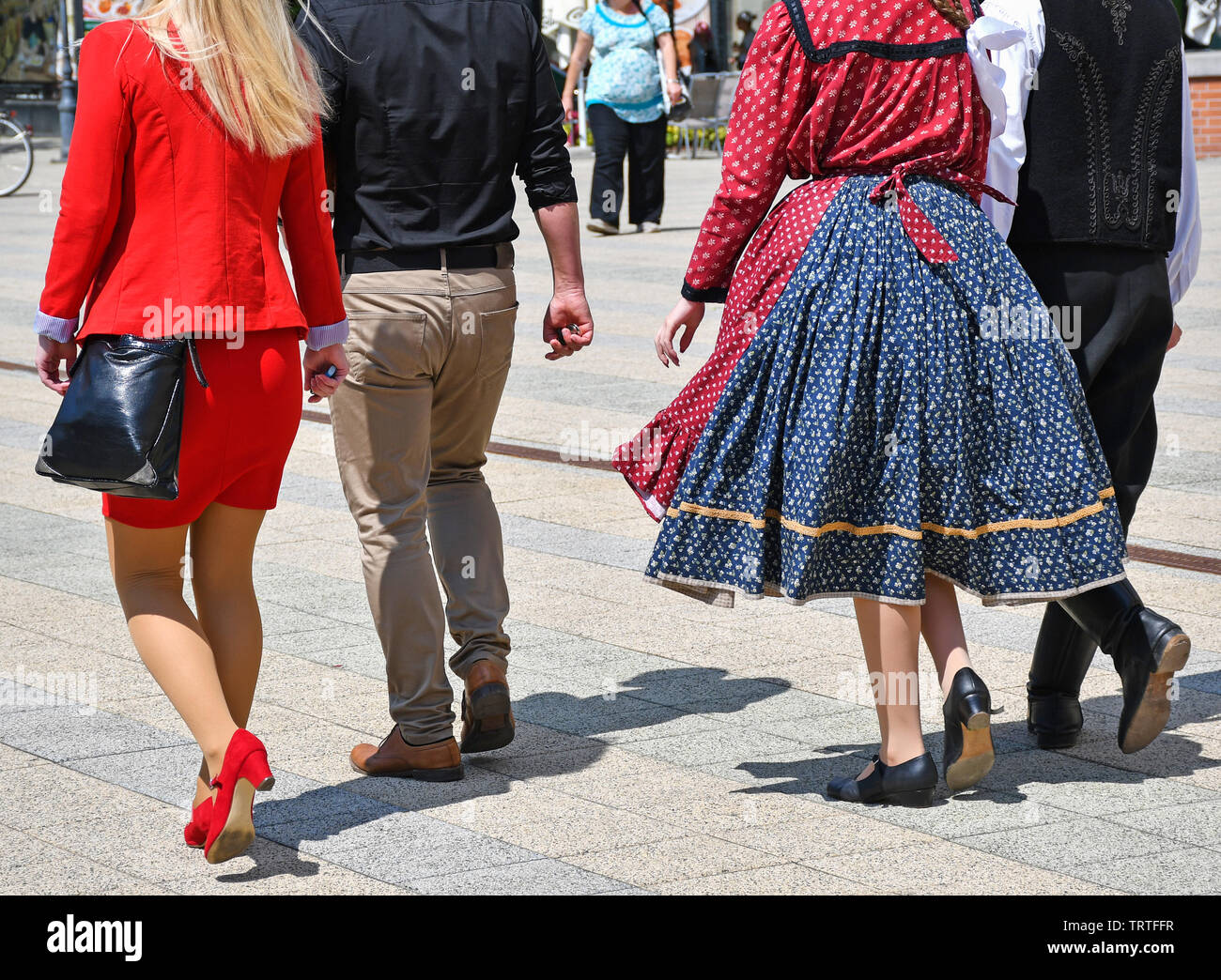 People on the street in regular and traditional clothing Stock Photo