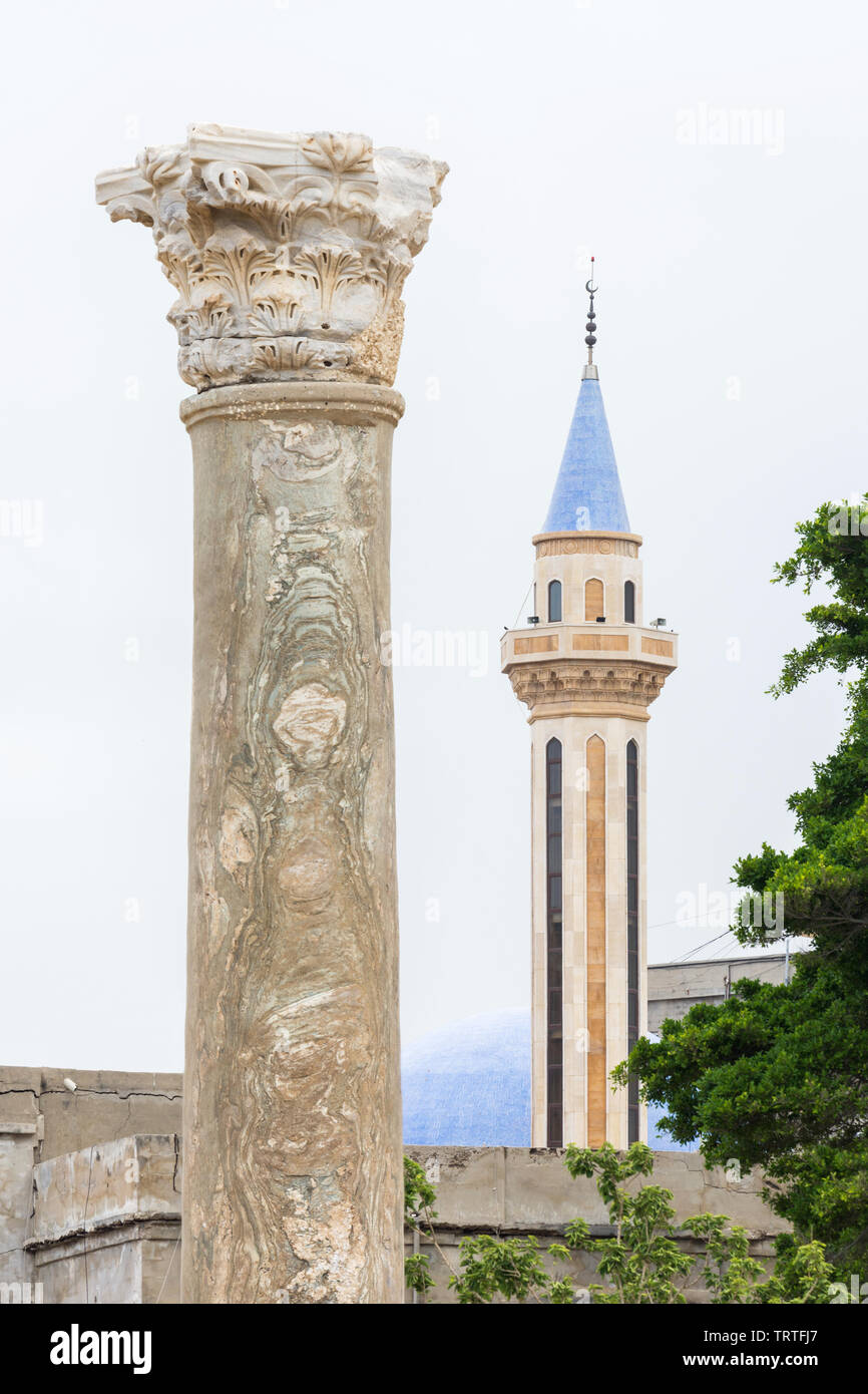 Roman columns and a mosque's minaret, Al Mina archaeological site, Tyre, Lebanon Stock Photo
