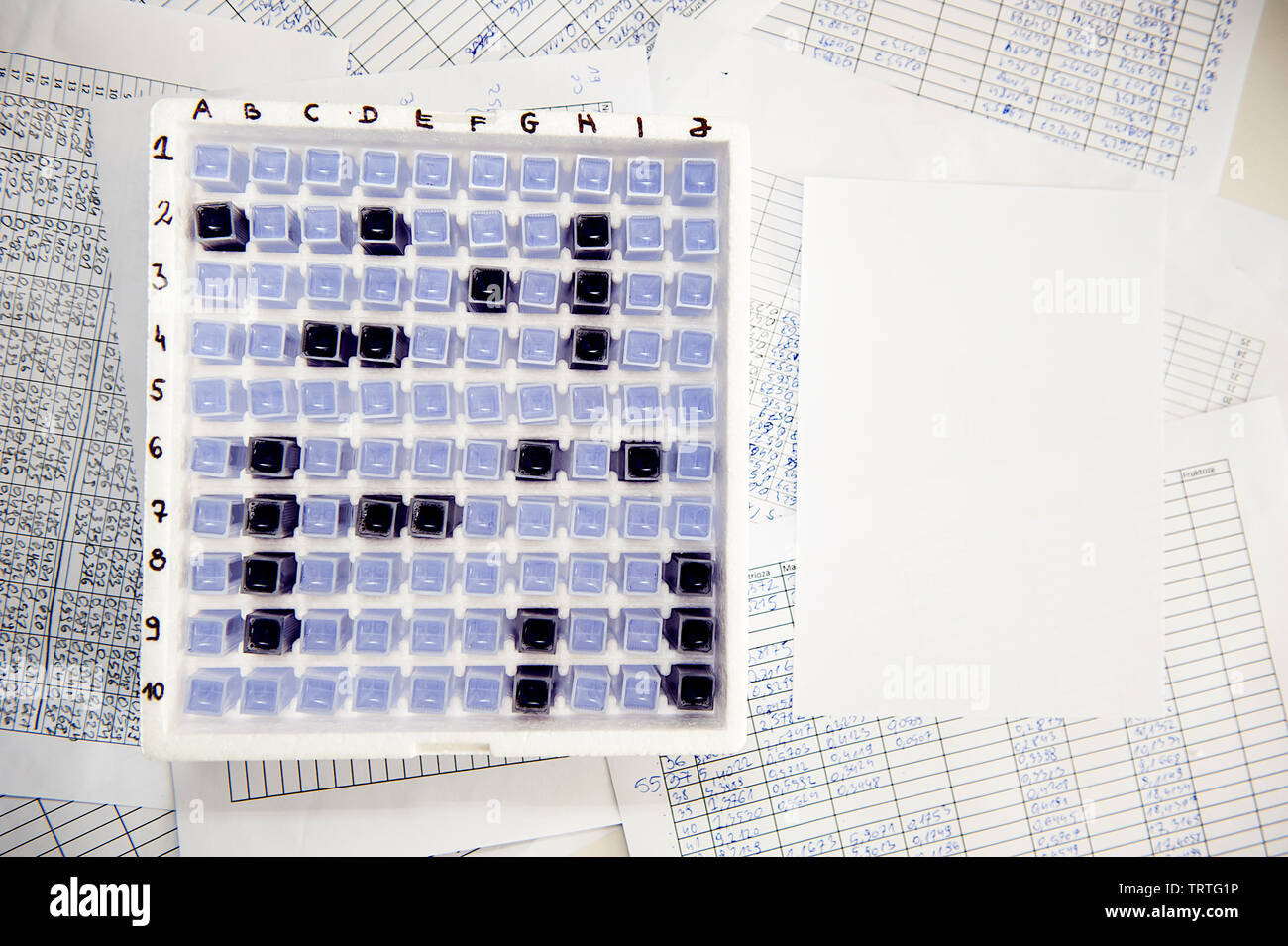 Laboratory battleship game made of spectrophotometer cuvette in a box