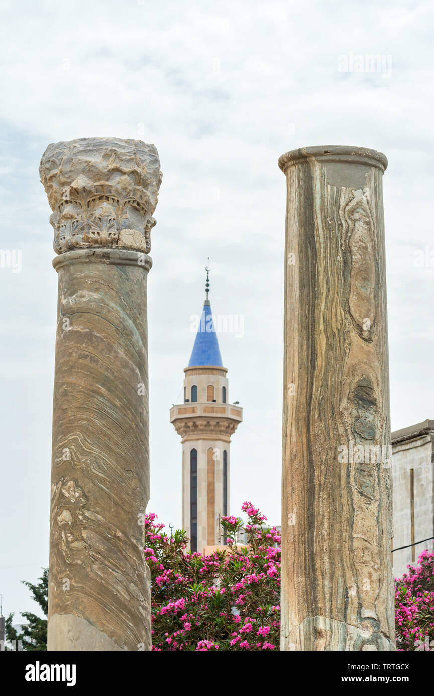 Roman columns and a mosque's minaret, Al Mina archaeological site, Tyre, Lebanon Stock Photo