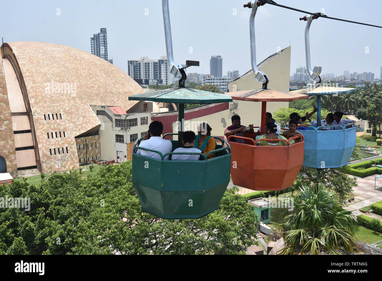 Overhead ropeway with buckets carrying visitors at the Science City ...