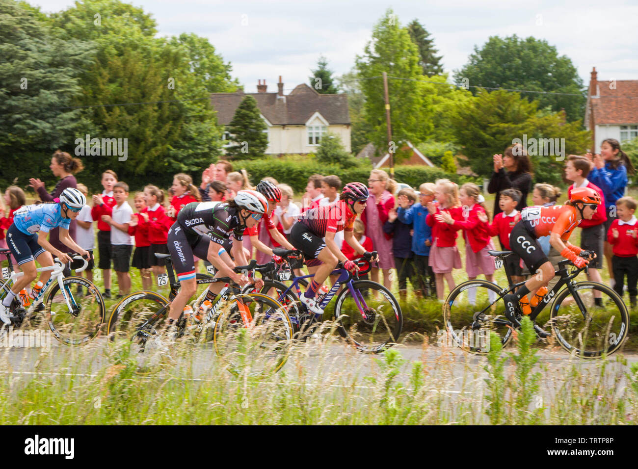 Peppard,Oxfordshire, UK, 12 June 2019.  Riders on the 3rd stage of the OVO Energy Women's tour through Oxfordshire are cheered on by children from Peppard Church of England Primary School. On the left Lizzie Deignan wears the pale blue Best British Rider Jersey. Credit: Harry Harrison/Alamy Live News Stock Photo