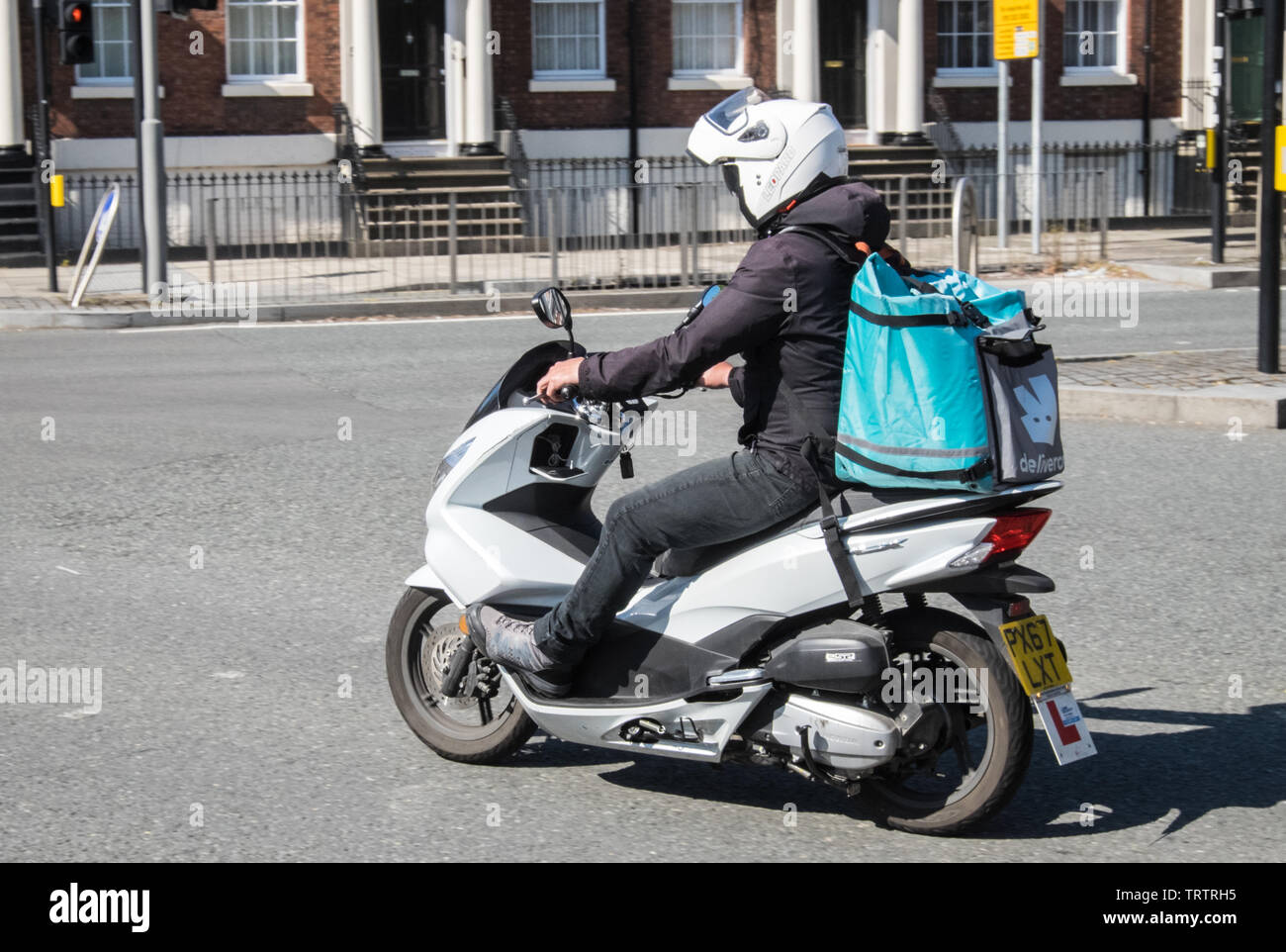 Deliveroo,food,courier,service,by,scooter,in,Liverpool,Merseyside,Northern,city,England,British,GB,UK,Great Britain,Britain,Europe, Stock Photo