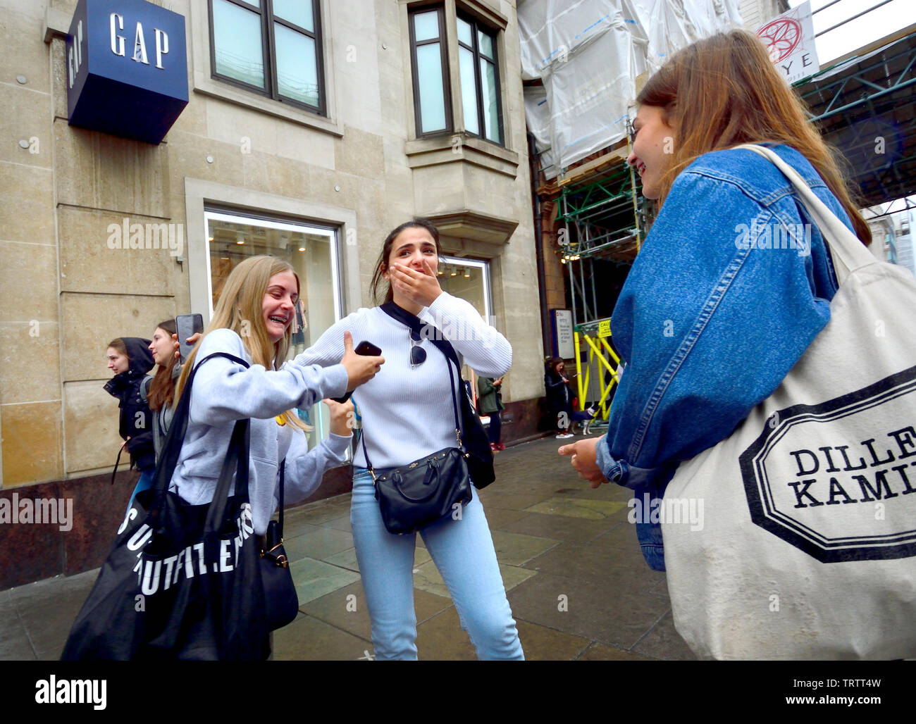 London, England, UK. Girls shopping in Oxford Street on a rainy day Stock Photo