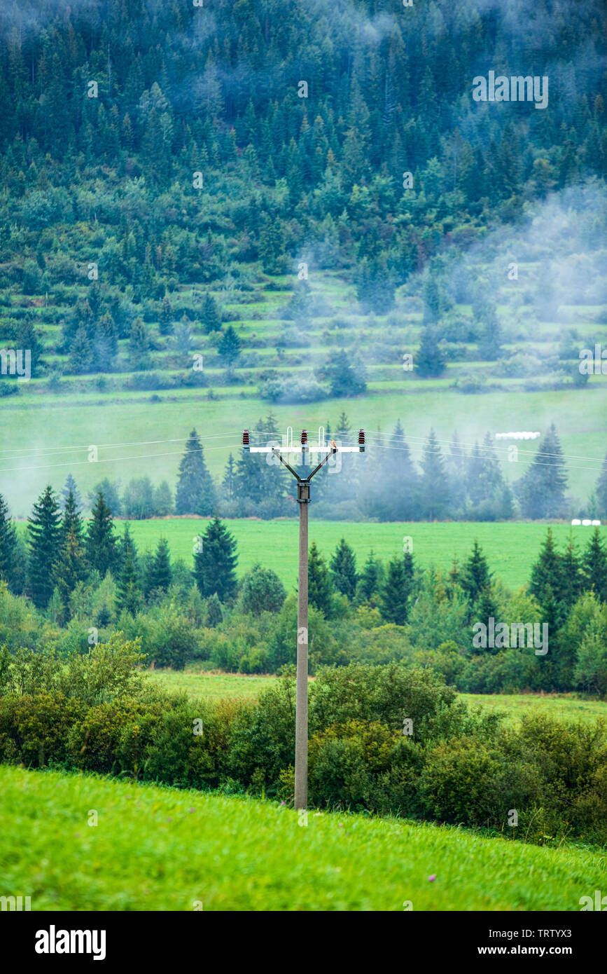 electricity power line poles construction in middle of fields in ...