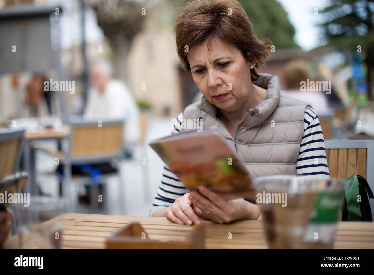 adult woman sitting outdoor  in a street cafe in Madrid, Spain Stock Photo