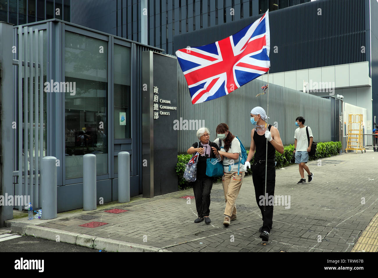 Hong Kong, China. 12th June, 2019. Alexandra Wong with unidentified protesters, one carries the flag of the United Kingdom during protests against extradition law in Hong Kong Credit: Thomas Bertson/Alamy Live News Stock Photo