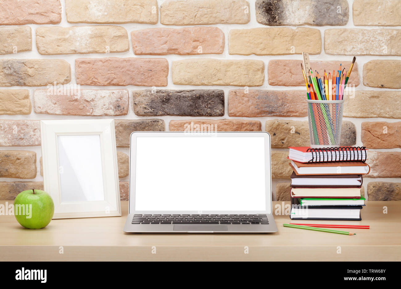 Office Desk Workplace With Laptop And Photo Frame In Front Of