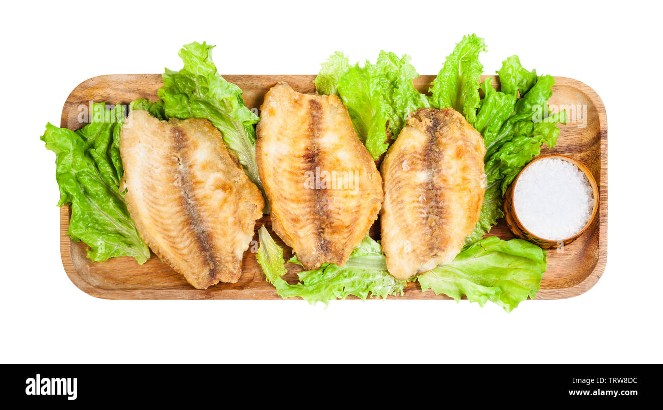 top view of fried ocean perch fillet on wooden tray isolated on white