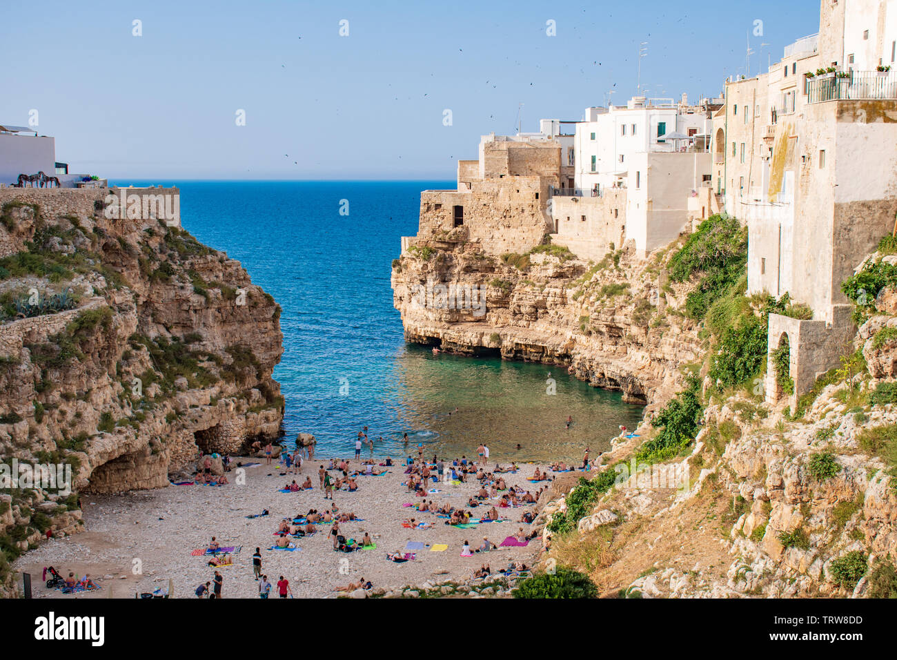 Panoramic city skyline with white houses and beach, town on the rocks, Puglia region, Italy, Europe. Traveling concept background with blue sea Stock Photo
