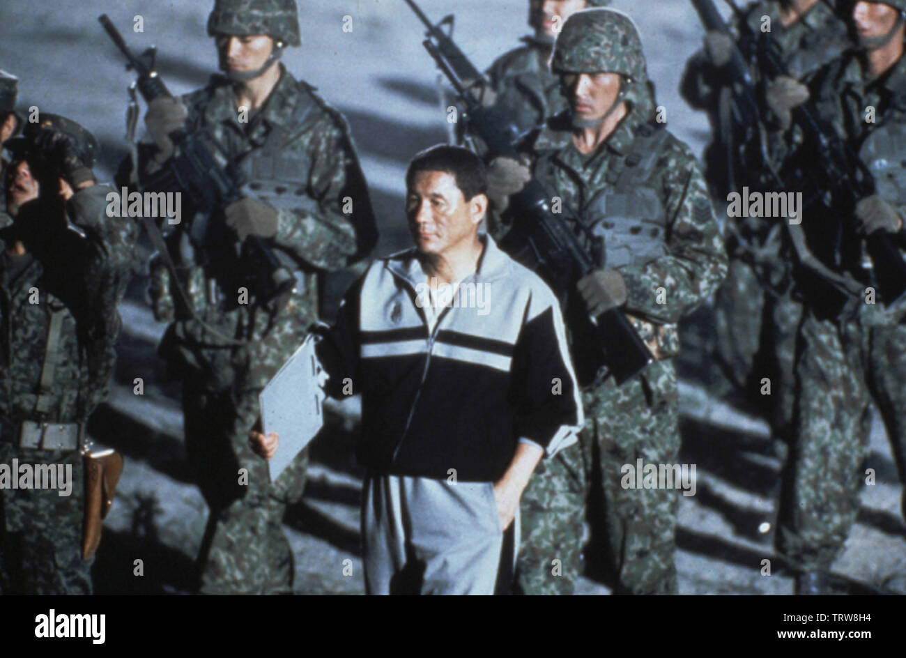TAKESHI KITANO in BATTLE ROYALE (2000) -Original title: BATORU ROWAIARU-. Copyright: Editorial use only. No merchandising or book covers. This is a publicly distributed handout. Access rights only, no license of copyright provided. Only to be reproduced in conjunction with promotion of this film. Credit: BATTLE ROYALE PRODUCTION COMMITTEE / Album Stock Photo