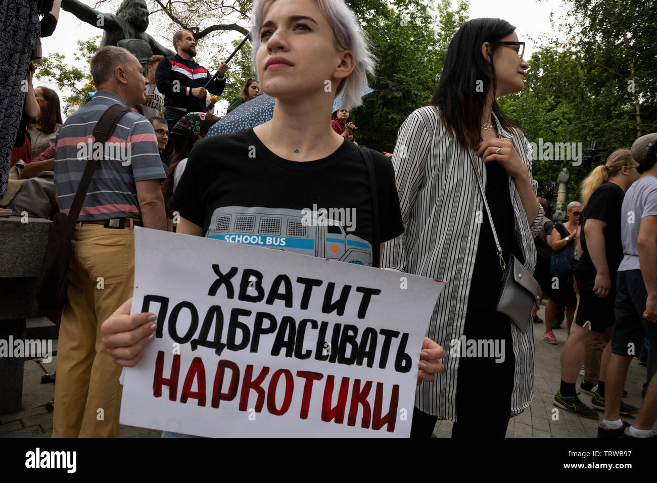 Moscow, Russia. 12th June, 2019 A girl holds banner during unauthorized march to protest against the alleged impunity of law enforcement agencies in central Moscow, Russia. The message reads: 'Stop planting drugs' Stock Photo