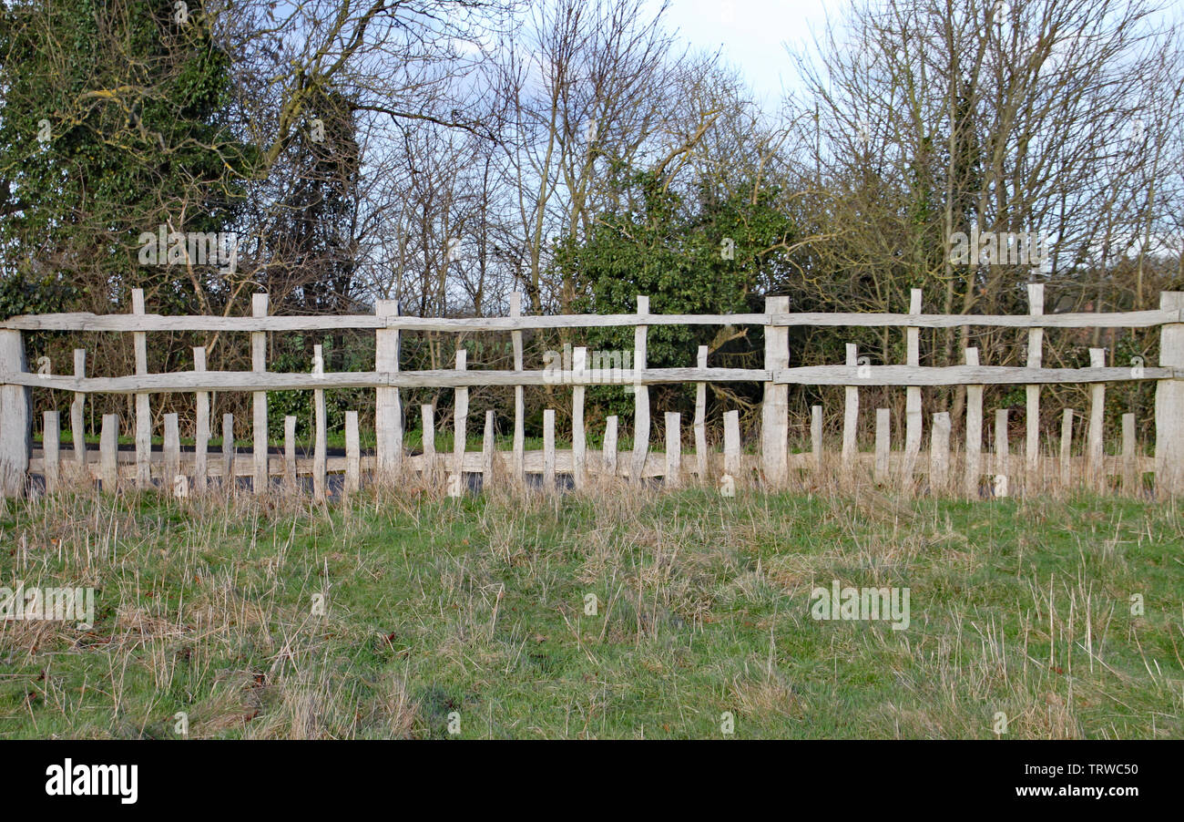 Unusual wooden fence with parallel horizontal rails and vertical posts