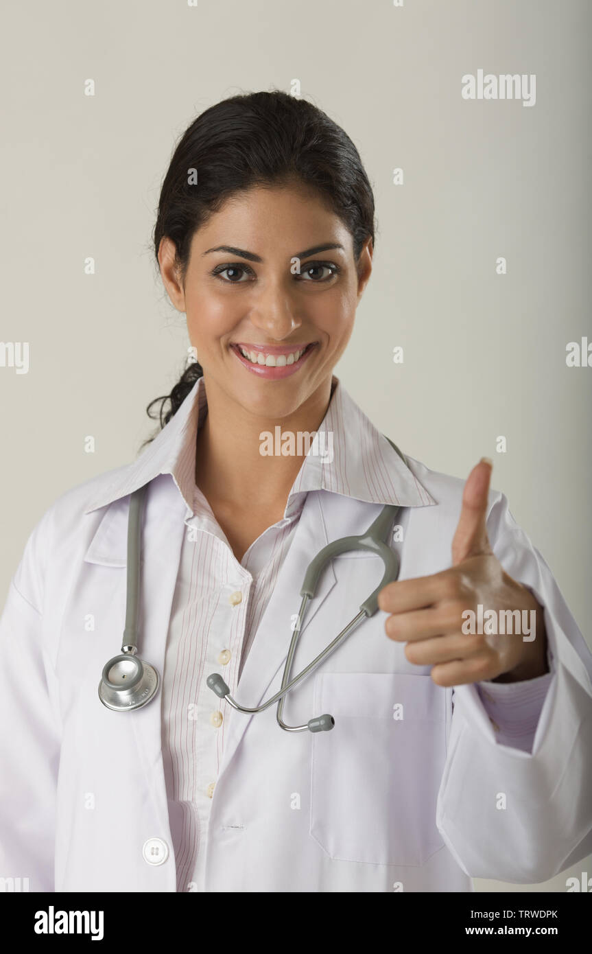 Indian female doctor showing her thumbs up and smiling Stock Photo - Alamy