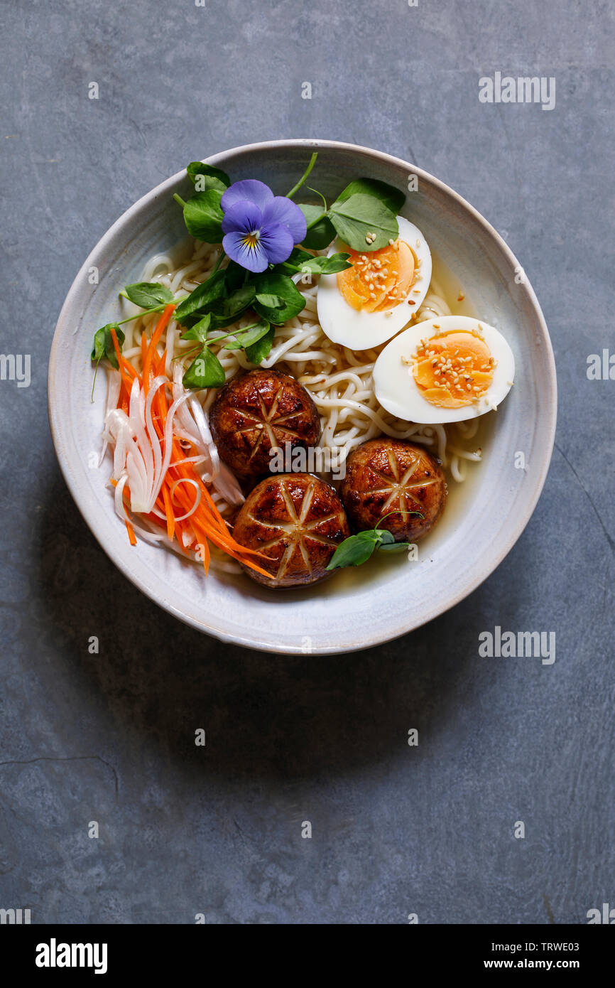 Japanese miso ramen with stuffed mushrooms, noodles and egg Stock Photo