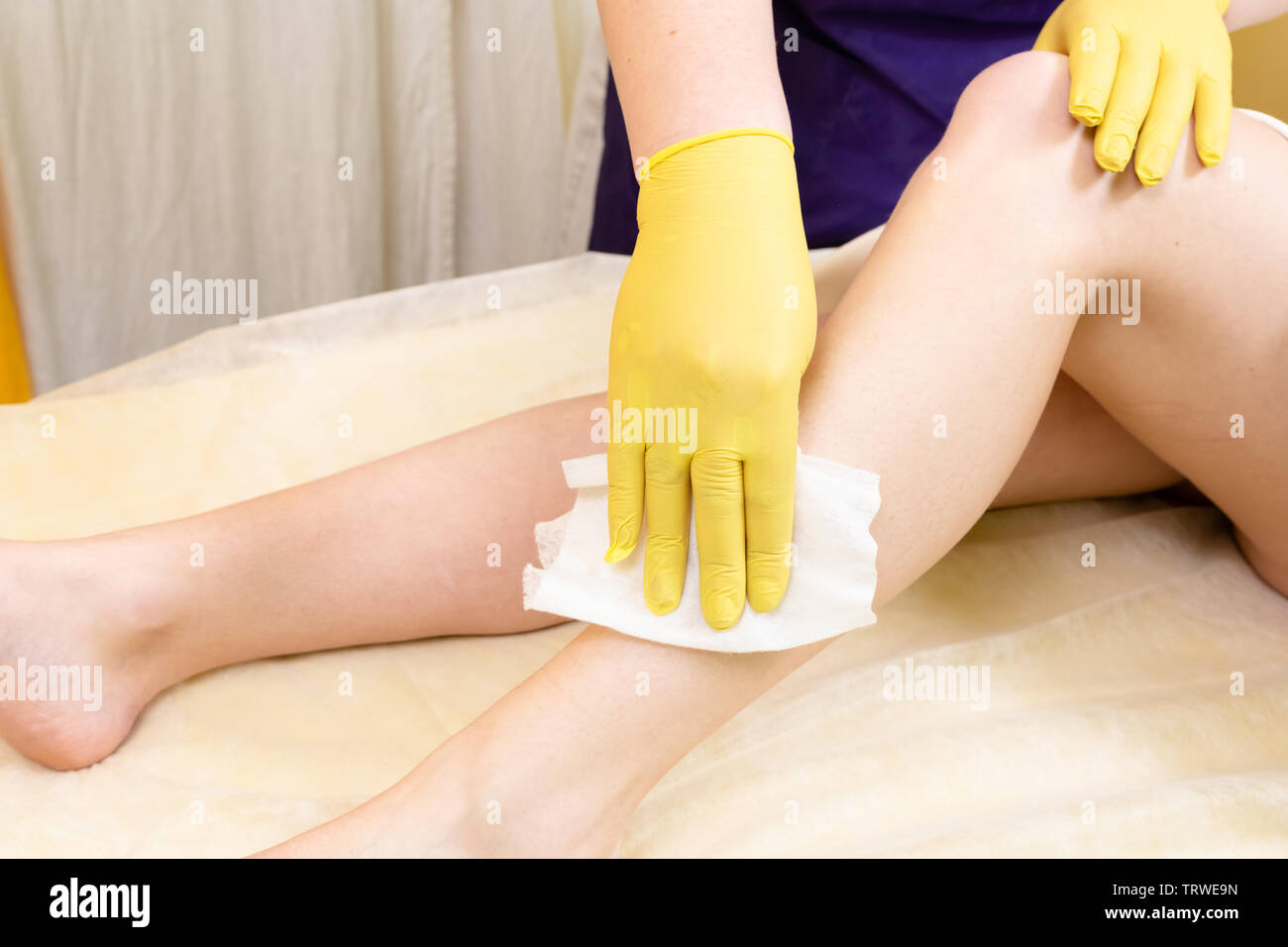 Method of hair removal sugar paste for sweetening c female body. The work and methods of the master are shown. Stock Photo