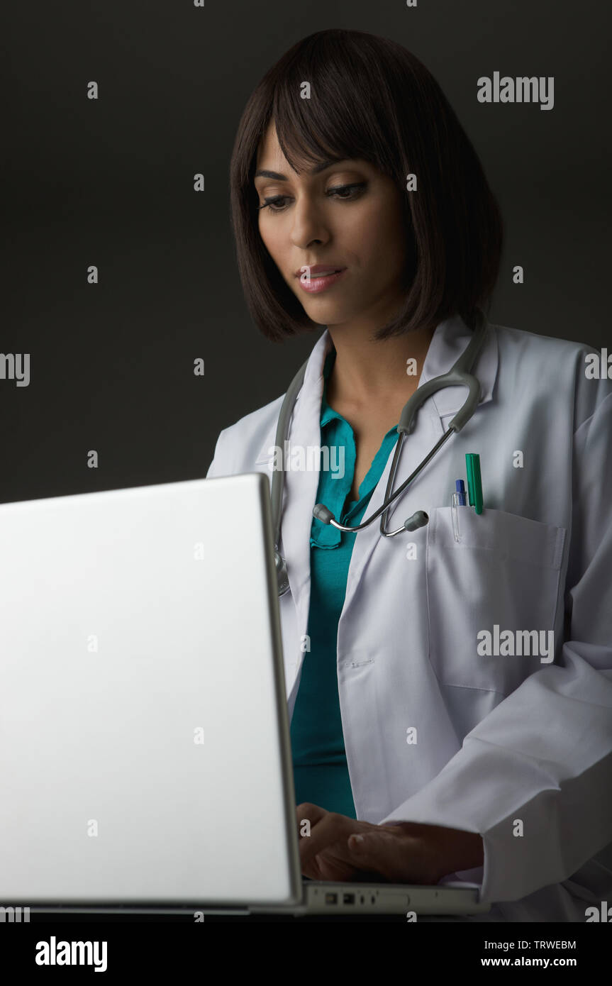Young female doctor typing hi-res stock photography and images - Alamy