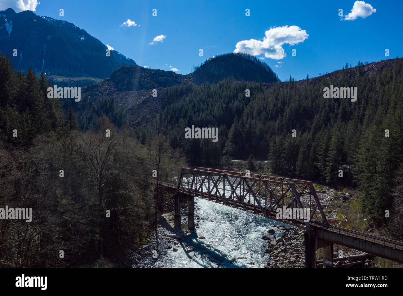 A BNSF train bridge, trestle, spans over the Skykomish river in central Washington state. Stock Photo