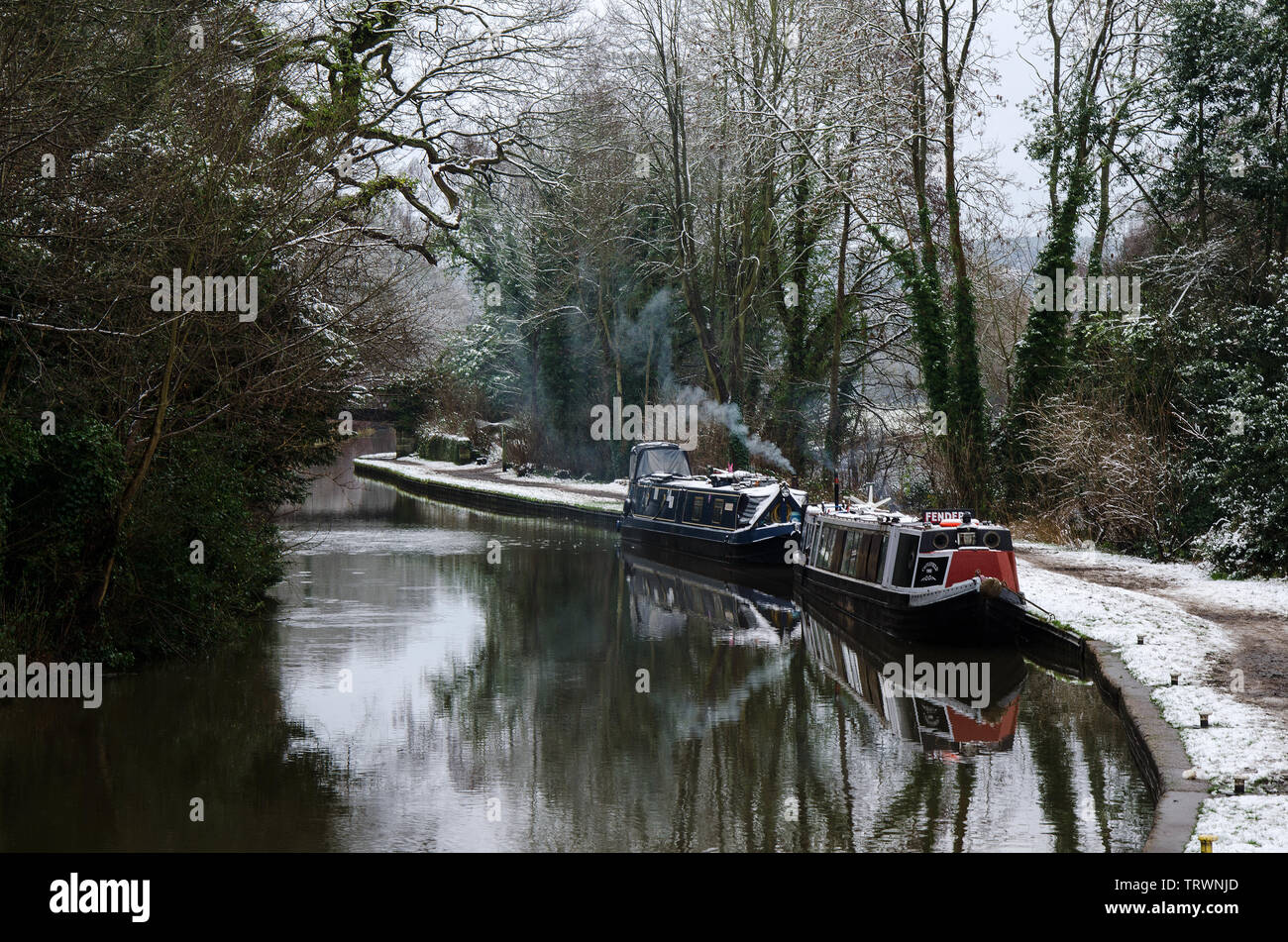 A delightful and tranquil scene of canal boats in winter along the Trent and Mersey canal at Great Haywood, Staffordshire. Stock Photo