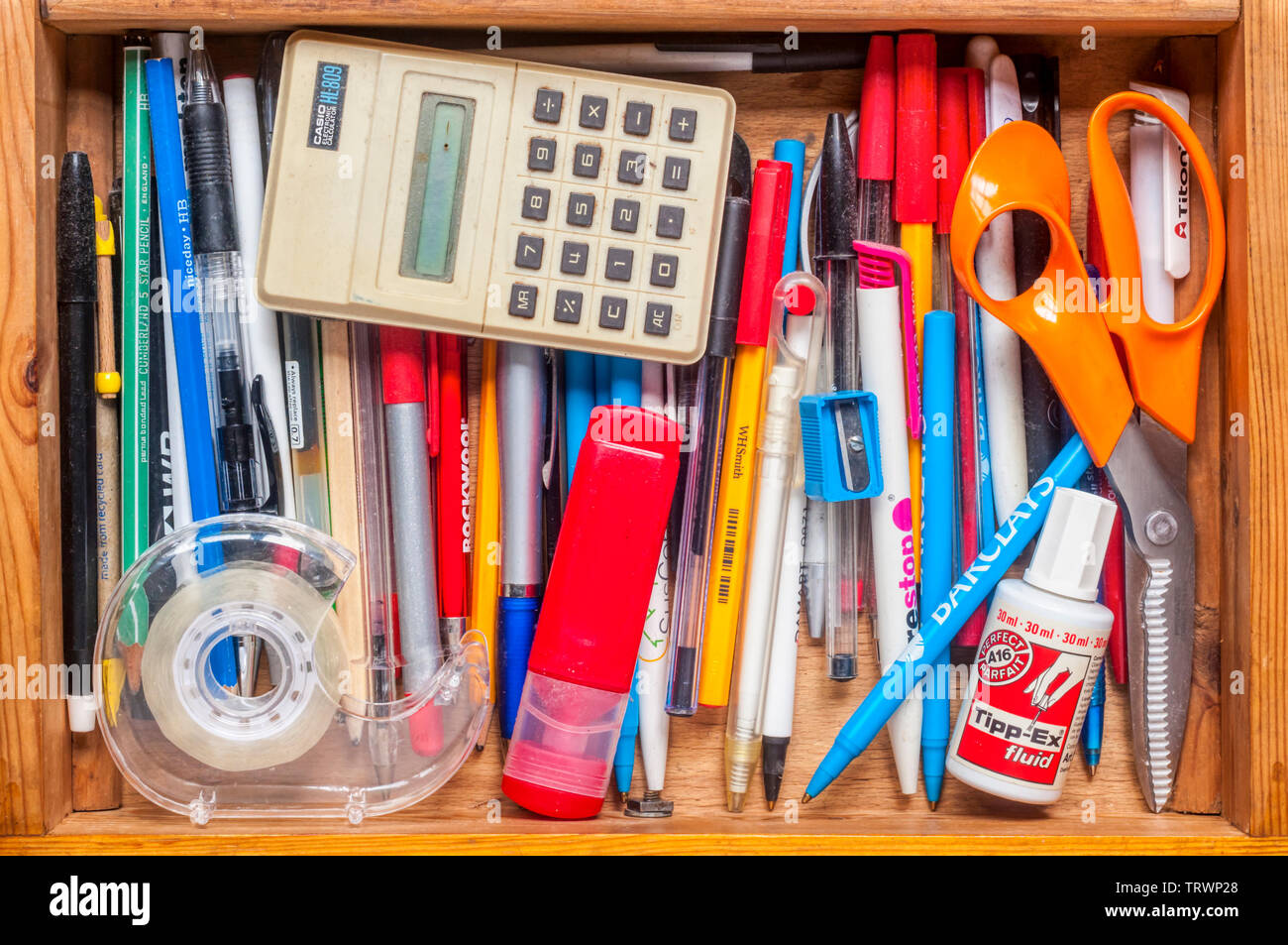 Stationery items stored in a drawer - pens, pencils and office equipment. Stock Photo