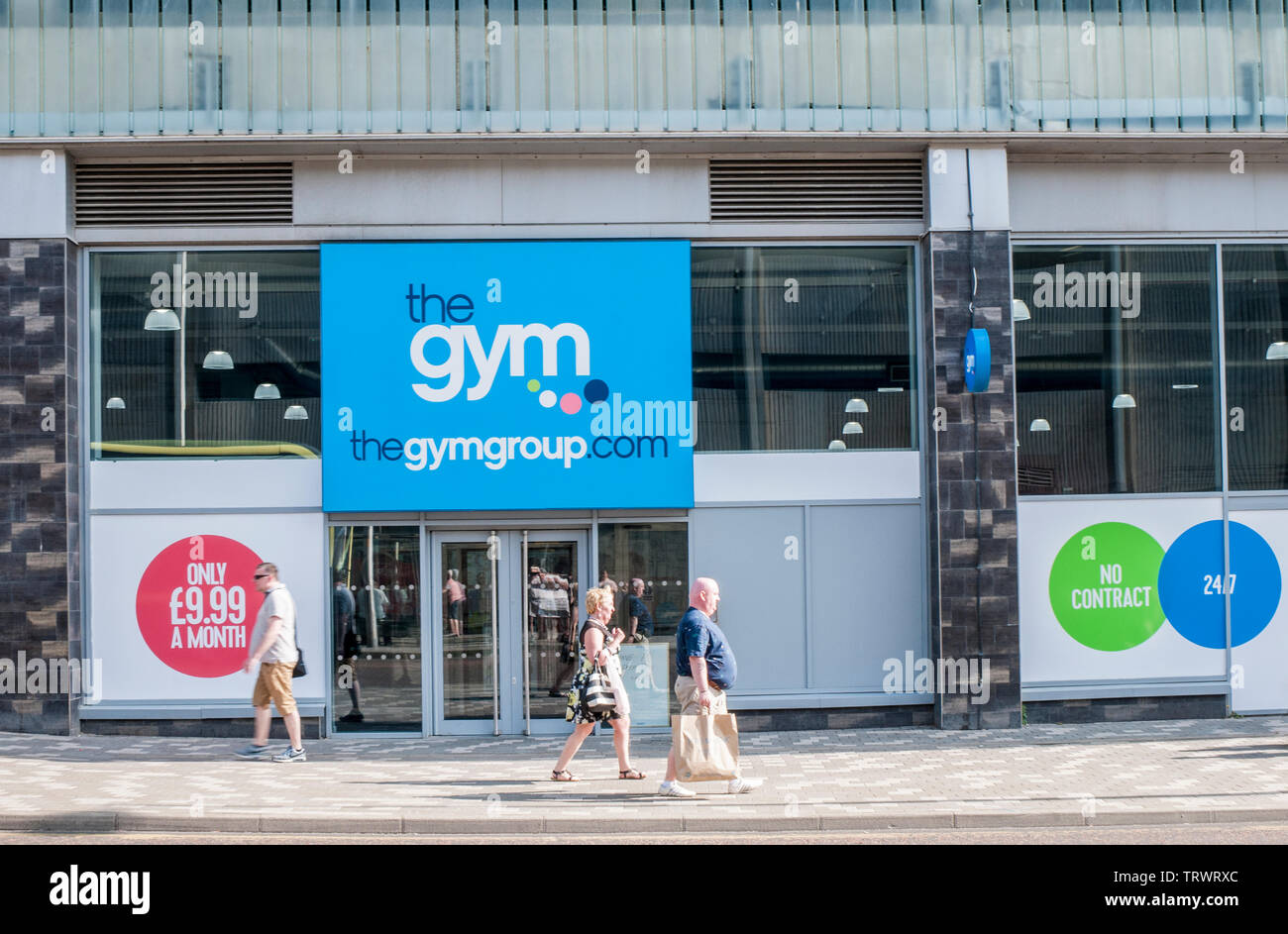 Front of the gym fitness centre with people walking past with shopping bags in Blackpool Lancashire England Stock Photo