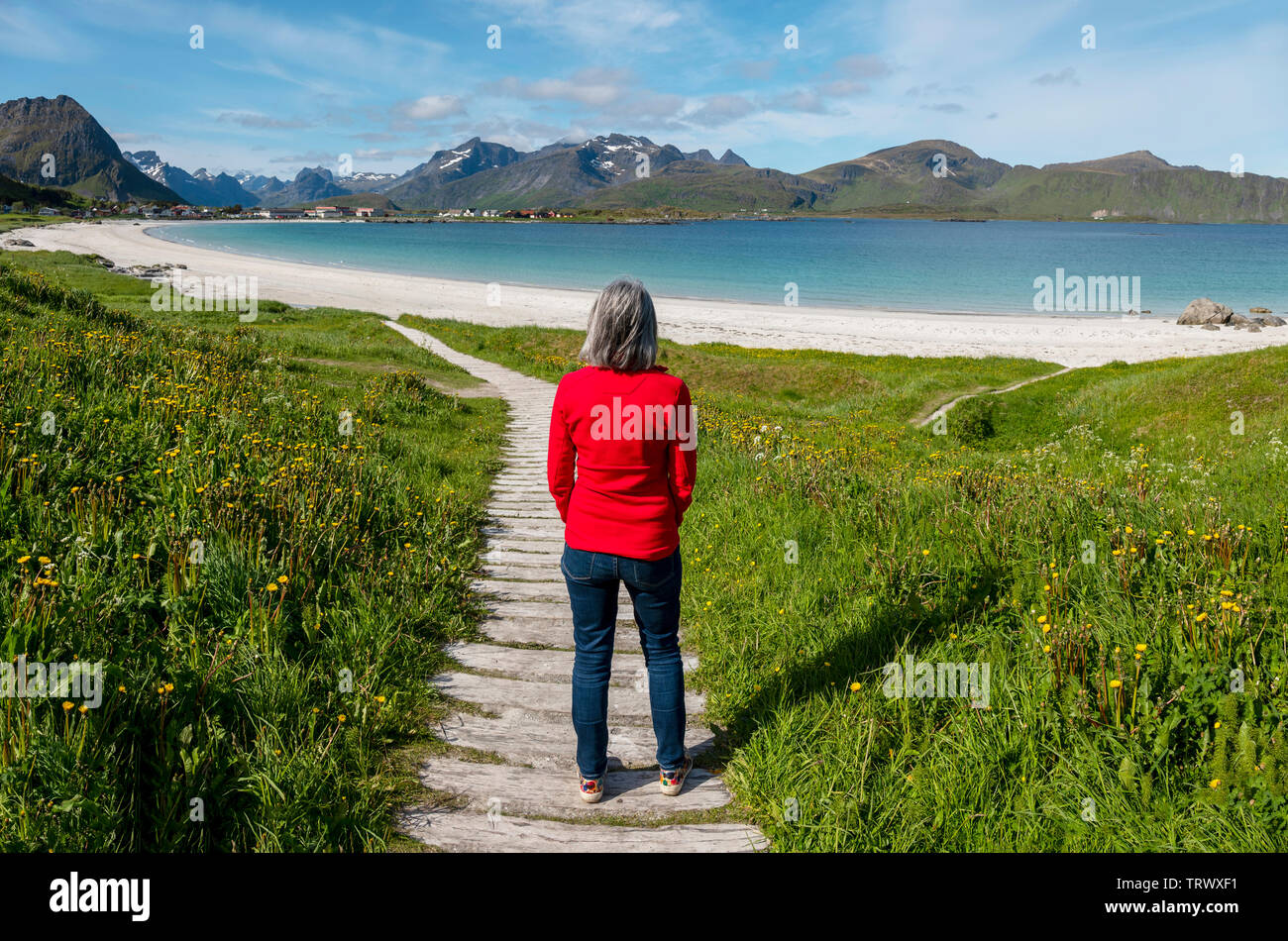 Mature woman on Ramberg Beach, Lofoten Islands, Norway. Stock Photo