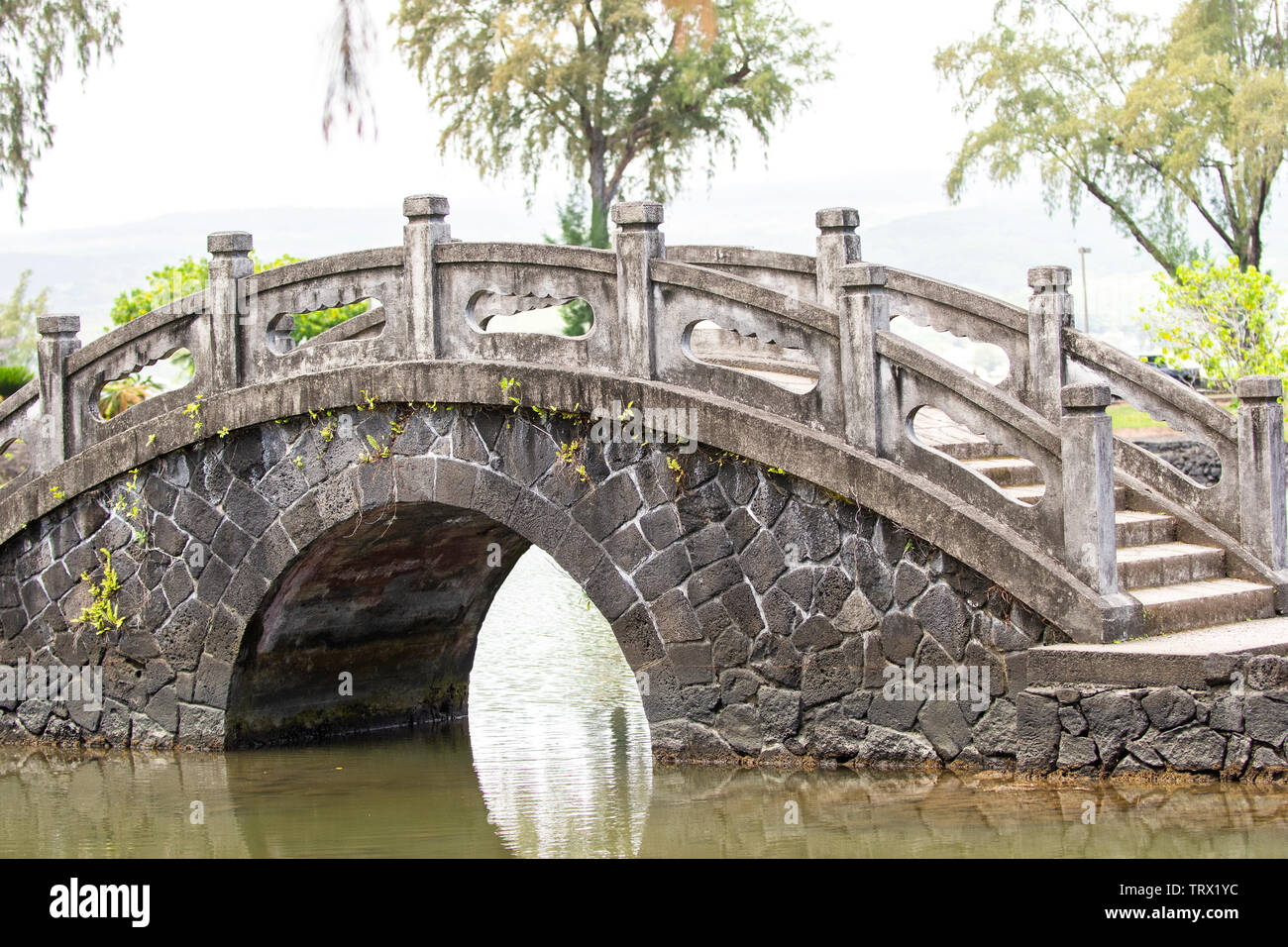 Bridge connecting two sides of a lake; Liliuokalani Gardens, Hilo
