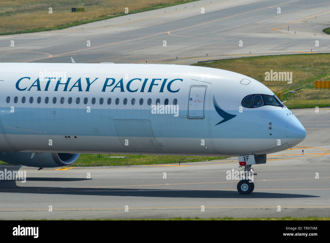 Osaka, Japan - Apr 19, 2019. Cathay Pacific B-LXF (Airbus A350-1000) taxiing on runway of Kansai Airport (KIX). The airport located on an artificial i Stock Photo