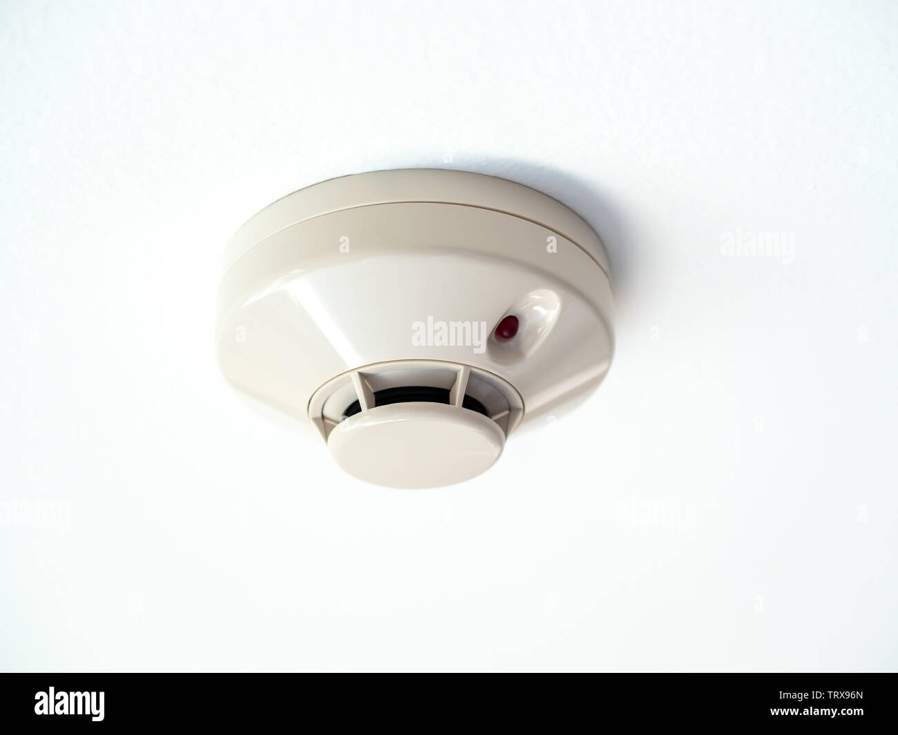 Smoke detector isolated on white ceiling background Stock Photo - Alamy
