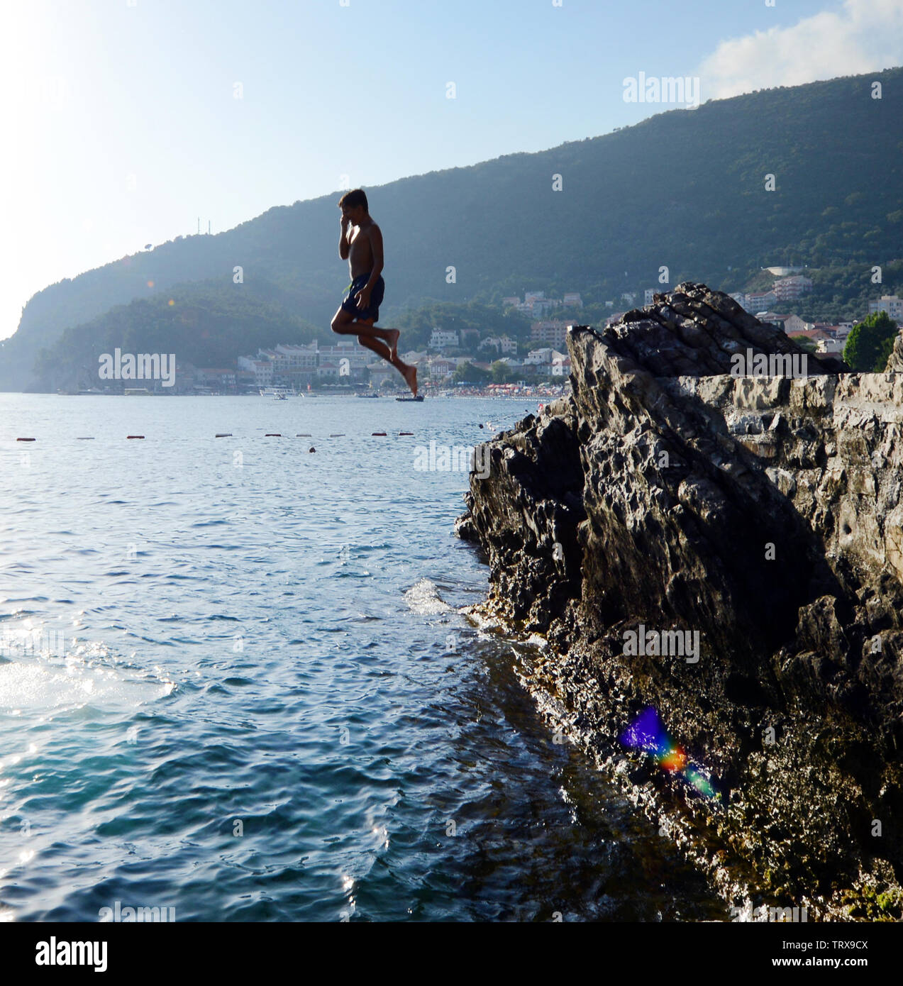 Jumping into the sea from the Ponta beach club restaurant. Stock Photo