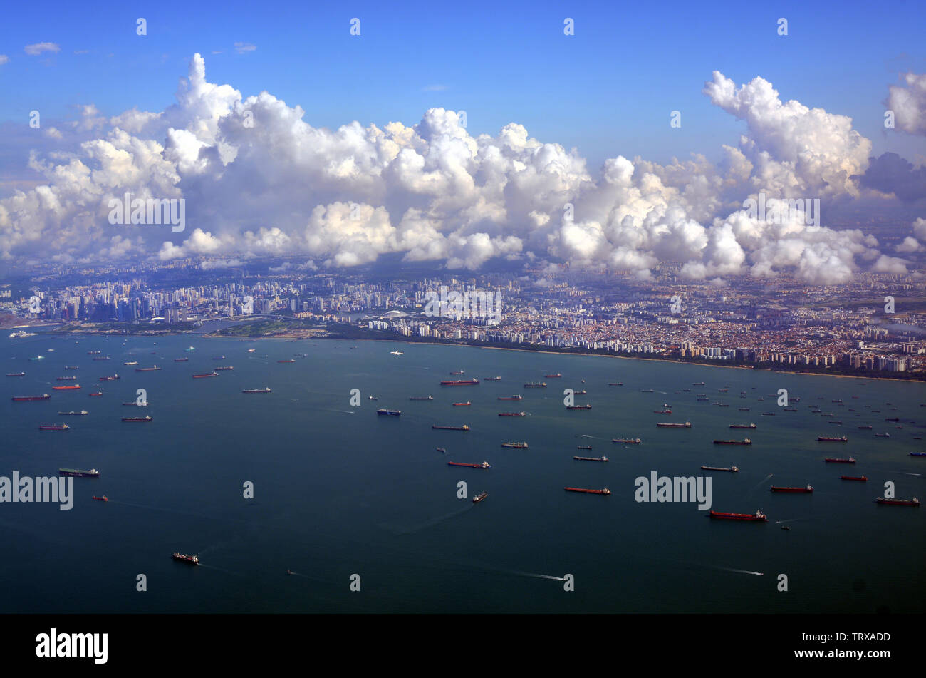 Departing Singapore - an aerial harbour, city and coastal panorama Stock Photo