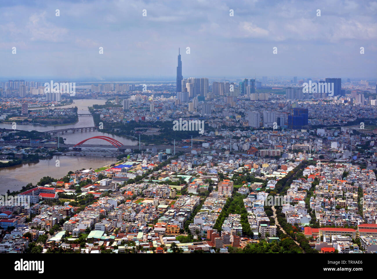 Arriving into Ho Chi Minh City, Vietnam - an aerial cityscape panorama featuring the Saigon River. Stock Photo